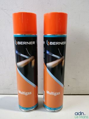 pair of two orange spray cans sitting on top of a white counter