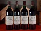three bottles of red wine sitting on a table next to a wooden box