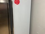a refrigerator in the corner of a kitchen with a box on top of it