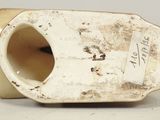 a white vase that has a tag on it