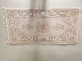 a rug hanging on the wall in a room