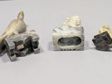 three pieces of stone with a bird on top of them