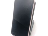 a cell phone that is sitting on top of a stand