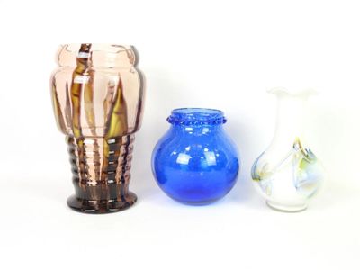 three vases sitting next to each other on a white surface