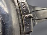 a close up of a silver plate with a clock on it