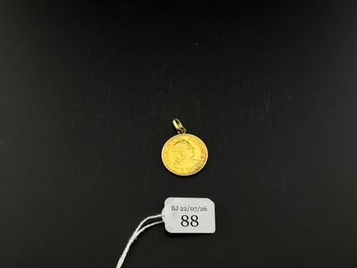 a close up of a coin on a black surface with a price tag