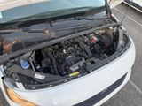 a white car with its hood open in a parking lot
