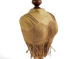 a mannequin on a wooden stand with a hat on it