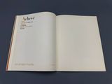 an open book on a table with a blue background