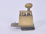 a small metal device that is sitting on a white surface