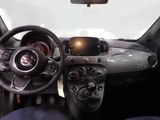 a car dashboard with a steering wheel and a dash light