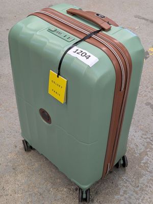 a suitcase with a tag on it sitting on the ground