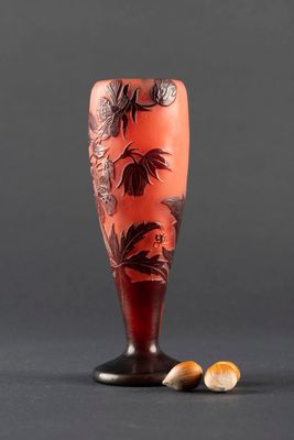 an image of a red vase with flowers on it