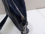 a black purse with a zipper on it on a table