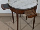 a marble top table with a drawer underneath it