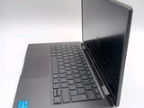 a laptop computer sitting on a table with a blue sticker on the keyboard