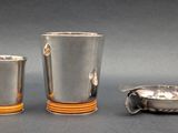two cups and a spoon sitting on a table