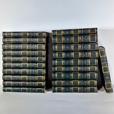 several books stacked on top of each other on a white surface