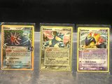 four pokemon cards are lined up on a counter top