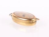 an image of a close up of a gold plated object on a white surface