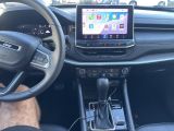 the interior of a car with a steering wheel, dashboard, and a touch screen