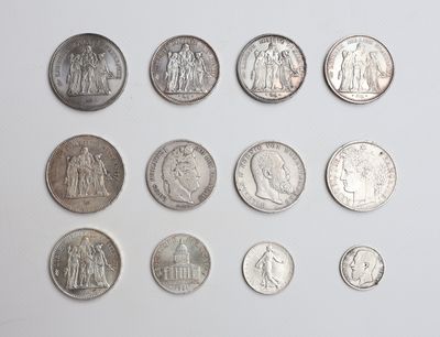a lot of coins that are on a white surface