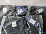 six pairs of black pants wrapped in plastic bags