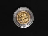 a close up of a gold coin on a black surface