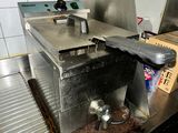 stainless steel counter top in a commercial kitchen with pots and pans on it