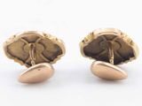 pair of gold tone cufflinks with a flower design on each side