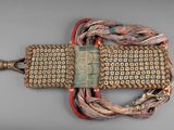 an image of a woven purse with a tag on it
