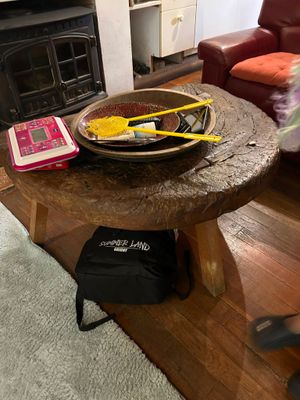 a wooden table with a bowl of food on top of it
