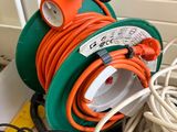 a green and orange hose sitting on top of a white box