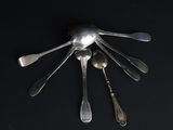 a lot of spoons and spoon spoons on a black surface