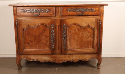an old wooden cabinet with two doors and a drawer on top of it
