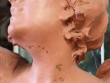 a statue of an angel that is made of clay
