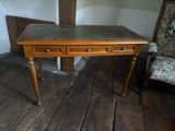 a wooden desk with two drawers and a chair in the corner