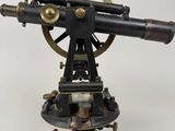 an antique brass and black telescope on a tripod stand