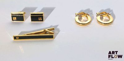 trois paires de boutons de manchette noirs et dorés, une paire de boutons de manchette noirs et dorés et une paire de boutons de manchette noirs et dorés