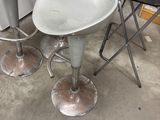 three stools and a table in a room