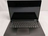 a laptop with a black keyboard sitting on a white surface