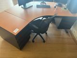 a desk with a chair and a computer on it