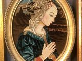 two framed pictures of a woman in a blue dress and a gold frame
