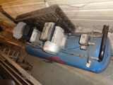 a blue air compressor sitting in a room next to a wall