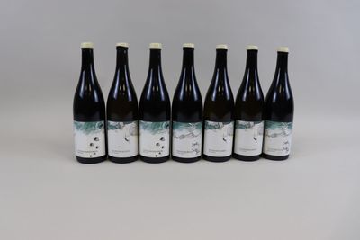 six bouteilles de vin alignées sur une table