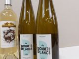 three bottles of wine sitting on top of a table next to each other