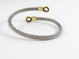 a pair of cable bracelets with gold clasps on a white background