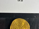 a close up of a gold coin on display in a glass case