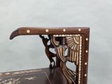 a wooden bench with a bird design on it
