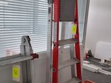 a ladder that is next to a window in a room